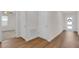 Bright foyer with wood-look flooring, white doors, and a view into adjacent rooms at 401 Chayne Pl, St Cloud, FL 34771