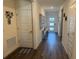 Bright hallway showcasing wood-look flooring, neutral paint, and a welcoming ambiance at 401 Chayne Pl, St Cloud, FL 34771