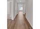 Open hallway with wood-look floors, connecting living areas and offering a bright, inviting passage at 401 Chayne Pl, St Cloud, FL 34771