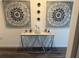 Decorative hallway table featuring modern artwork, candles and personal photos at 401 Chayne Pl, St Cloud, FL 34771