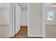 Hallway with view into the bathroom on the right and a carpeted room on the left at 401 Chayne Pl, St Cloud, FL 34771