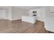 Kitchen and living room area with white kitchen island, stainless appliances, and wood-look flooring at 401 Chayne Pl, St Cloud, FL 34771