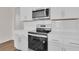Bright kitchen featuring stainless steel appliances and white cabinets with a subway tile backsplash at 401 Chayne Pl, St Cloud, FL 34771