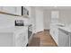 Modern kitchen with white cabinets, stainless steel appliances, and wood flooring at 401 Chayne Pl, St Cloud, FL 34771