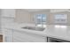 Kitchen island featuring a stainless steel sink with modern faucet and white countertops at 401 Chayne Pl, St Cloud, FL 34771