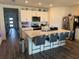 Bright kitchen with white cabinetry, stainless steel appliances, a spacious island with barstool seating at 401 Chayne Pl, St Cloud, FL 34771