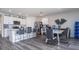 Open kitchen and dining area with bar seating, a stainless steel refrigerator, and hardwood style flooring throughout at 401 Chayne Pl, St Cloud, FL 34771