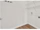 A minimal laundry room has laminate flooring and metal shelving at 401 Chayne Pl, St Cloud, FL 34771