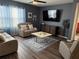 Inviting living room with a plush reclining sofa and a sleek entertainment center at 401 Chayne Pl, St Cloud, FL 34771
