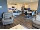 Open-concept living space with a modern kitchen, dining area, and comfortable seating featuring hardwood style floors at 401 Chayne Pl, St Cloud, FL 34771