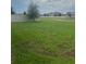 Green backyard with a large grassy area, surrounded by a privacy fence at 4033 Sunrise Ridge Blvd, Groveland, FL 34736