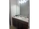 Bathroom features a double vanity with a large mirror, providing functionality at 4033 Sunrise Ridge Blvd, Groveland, FL 34736