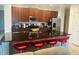 Kitchen featuring stainless appliances, dark wood cabinets, and seating area at 4033 Sunrise Ridge Blvd, Groveland, FL 34736