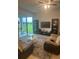 Spacious living room featuring sliding glass doors overlooking manicured lawn at 4033 Sunrise Ridge Blvd, Groveland, FL 34736