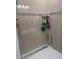 Walk-in shower features modern fixtures and tiled walls, with a glass door at 4033 Sunrise Ridge Blvd, Groveland, FL 34736