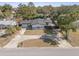 An aerial perspective reveals a cozy single-story home nestled among trees, enhanced by a spacious driveway at 45 S Edgemon Ave, Winter Springs, FL 32708