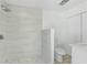 Modern bathroom featuring a walk-in shower with marble tiling, a white vanity, and a toilet at 45 S Edgemon Ave, Winter Springs, FL 32708