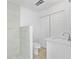 Modern bathroom featuring a walk-in shower with marble tiling, a white vanity, and a toilet at 45 S Edgemon Ave, Winter Springs, FL 32708