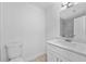 Bathroom features a toilet, vanity with white cabinets, quartz counters, and tile surround shower at 45 S Edgemon Ave, Winter Springs, FL 32708