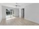 Bright bedroom features light wood floors, a sliding glass door, and two additional interior doors at 45 S Edgemon Ave, Winter Springs, FL 32708