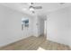 This bedroom has light wood floors, a ceiling fan, a window, and a closet at 45 S Edgemon Ave, Winter Springs, FL 32708