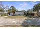 The front exterior of a single-story home features a minimalist design, complemented by a well-maintained lawn and landscaping at 45 S Edgemon Ave, Winter Springs, FL 32708