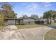 The front exterior showcases a single-story house with a long driveway, complemented by a minimalist design and landscaping at 45 S Edgemon Ave, Winter Springs, FL 32708
