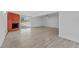 Open living room features brick fireplace, wood-look floors, and sliding glass doors at 45 S Edgemon Ave, Winter Springs, FL 32708