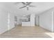 Open-concept living room with light wood floors and a view into kitchen at 45 S Edgemon Ave, Winter Springs, FL 32708