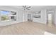 Open-concept living room with light wood floors and a view into kitchen at 45 S Edgemon Ave, Winter Springs, FL 32708