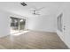 Bright living room with light wood floors, ceiling fan and sliding door at 45 S Edgemon Ave, Winter Springs, FL 32708