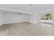 Open living room with light wood floors, a ceiling fan, and sliding glass doors to the backyard at 45 S Edgemon Ave, Winter Springs, FL 32708