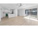 Open-concept living room with light wood floors and a view into kitchen at 45 S Edgemon Ave, Winter Springs, FL 32708