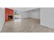 Open living room features brick fireplace, wood-look floors, and sliding glass doors at 45 S Edgemon Ave, Winter Springs, FL 32708