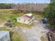 Aerial view of a single story home on a large lot with pond at 4771 Deen Still Rd, Polk City, FL 33868
