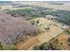 Aerial view of property with multiple structures and a pond at 4771 Deen Still Rd, Polk City, FL 33868