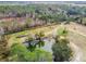 Aerial view of a pond surrounded by trees and buildings at 4771 Deen Still Rd, Polk City, FL 33868