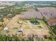Aerial view of property with pond, multiple structures, and surrounding land at 4771 Deen Still Rd, Polk City, FL 33868
