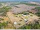 Aerial view of property with buildings, pond and surrounding land at 4771 Deen Still Rd, Polk City, FL 33868