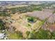 Aerial view of property showcasing buildings, pond, and surrounding landscape at 4771 Deen Still Rd, Polk City, FL 33868