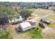 Aerial view of home, pond, and large lot with outbuildings at 4771 Deen Still Rd, Polk City, FL 33868