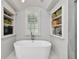 Relaxing bathroom with a freestanding tub and built-in shelving at 510 Golfpark Dr, Celebration, FL 34747