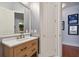 Bathroom with light wood vanity and a large mirror at 510 Golfpark Dr, Celebration, FL 34747
