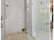Spa-like shower with pebble floor and glass enclosure at 510 Golfpark Dr, Celebration, FL 34747