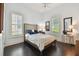 Bright bedroom with a queen-size bed and wood floors at 510 Golfpark Dr, Celebration, FL 34747