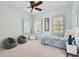 Light and bright bedroom with a comfy bed and seating at 510 Golfpark Dr, Celebration, FL 34747