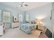 Light blue bedroom with white dresser and bed at 510 Golfpark Dr, Celebration, FL 34747