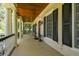 Spacious front porch with white columns and wooden flooring at 510 Golfpark Dr, Celebration, FL 34747