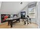 Game room featuring air hockey table, drum set, and framed jerseys at 510 Golfpark Dr, Celebration, FL 34747