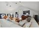 Game room boasts a sectional sofa, a coffee table, and a large TV at 510 Golfpark Dr, Celebration, FL 34747